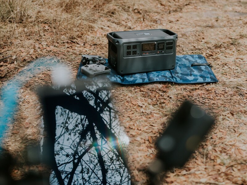 Portable power station on a table powering everyday devices indoors