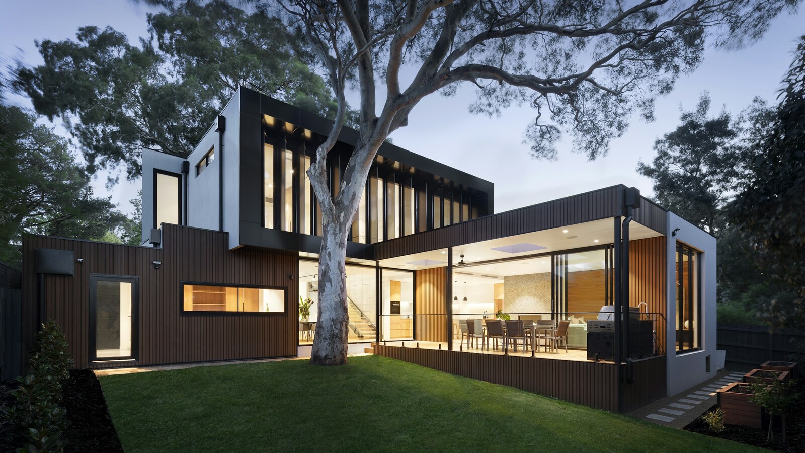 Quiet home exterior at dusk with porch lights on — planning backup power for ordinary evenings
