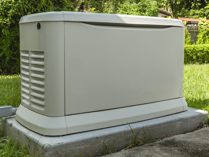 Standby generator enclosure installed on a concrete pad