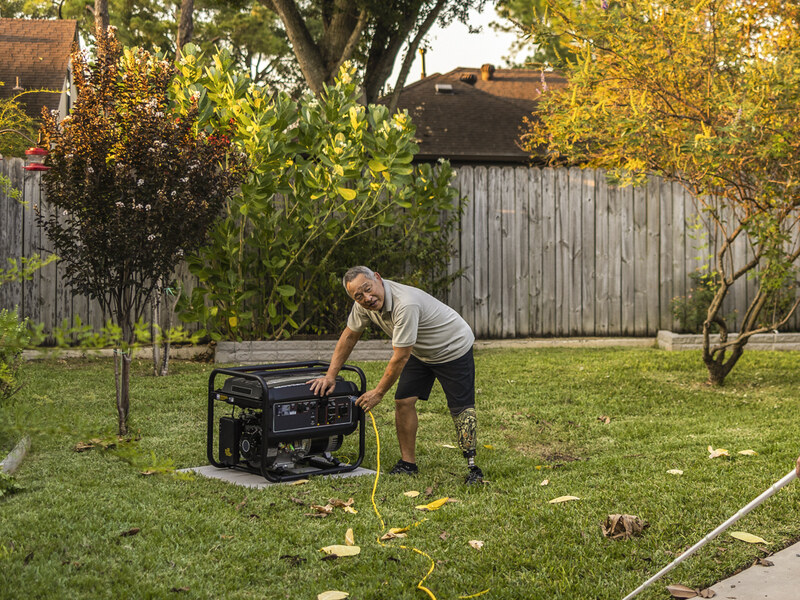 Compact portable generator on wheels in a residential outdoor setting