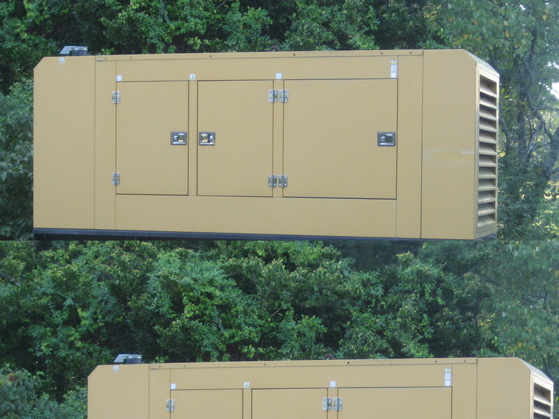 Standby generator installed on a pad beside a home